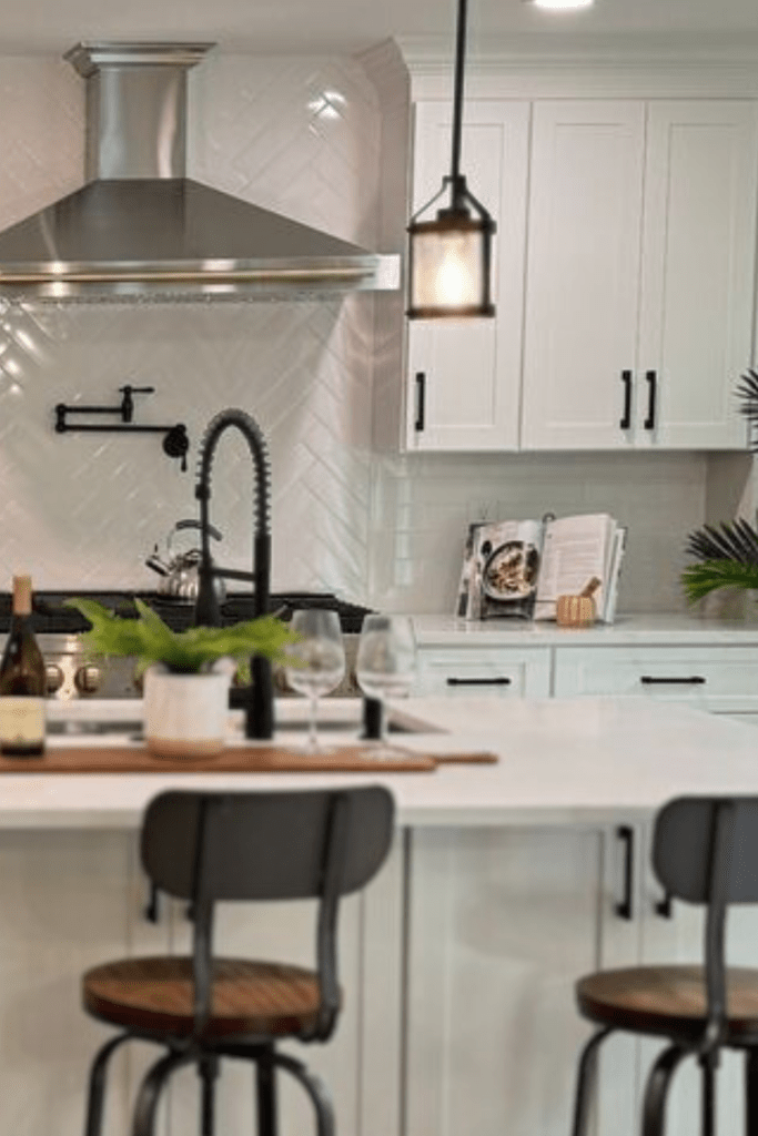 Open-concept kitchen renovation with real wood flooring, new cabinets and kitchen island, countertops, and lighting.