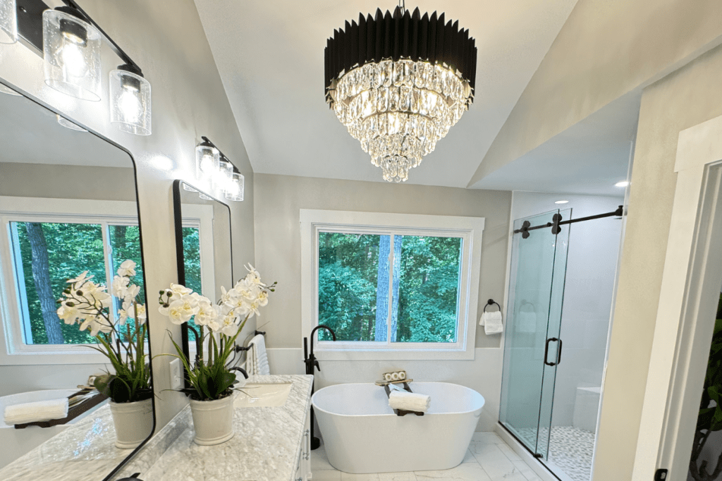 Bathroom remodel with new tile installation, updated lighting, and fresh interior paint.